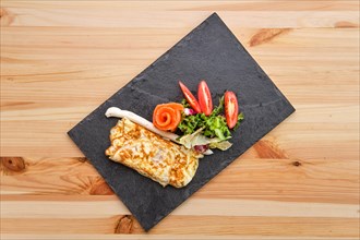Omelette with salmon on slate plate