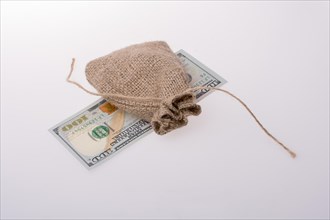Banknote of US dollar placed under a linen sack