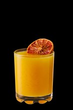 Hot orange and honey winter drink isolated on black