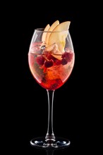 Cold sangria in a wine glass isolated on black background