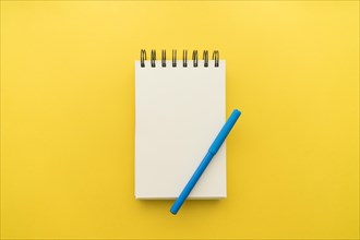 Notepad with pen yellow background. Resolution and high quality beautiful photo