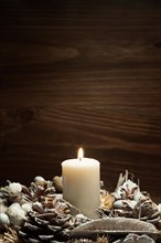 White candle lit with pine cone ornaments. Resolution and high quality beautiful photo