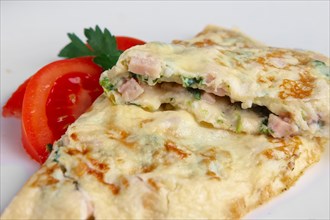Closeup of omelet with ham and vegetables. Selective focus photo