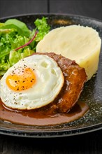 Closeup view of beef cutlet with fried egg