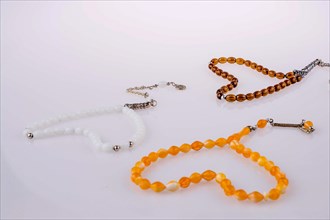 Heart shaped praying beads on a white background