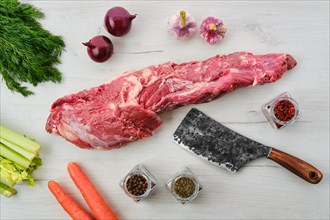 Raw fresh beef whole tenderloin with spice and herbs on wooden background