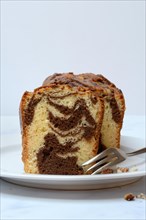 Marble cake with cake fork on plate