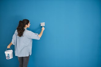 Woman painting blue wall. Resolution and high quality beautiful photo
