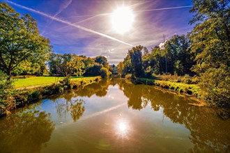 Hagenburg Canal with view to Hagenburg Castle in autumn with blue sky and sunshine