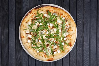 Top view of pizza with different kind of cheese with arugula