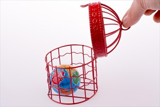 Small globe trapped in a red birdcage
