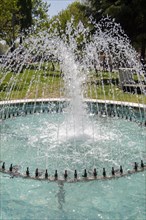 The fountains gushing sparkling water in a pool in a park