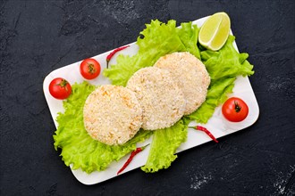 Top view of trout meat cutlet in breading