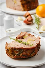 Closeup view of slice of pork neck baked in oven on a plate