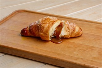 Teared croissant with flowing out chocolate filling