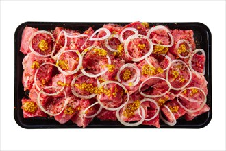 Tray with marinated meat cutted on pieces and ready for shashlik or kebab isolated on white