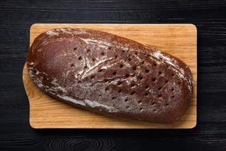 Top view of yeast-free brown bread on wooden cutting board