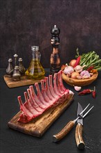 Fresh lamb ribs on the cutting board. Raw meat with garlic