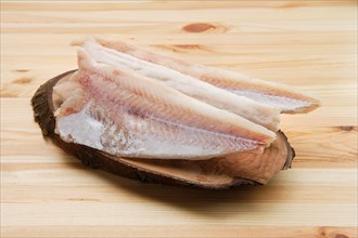 Frozen fillet of pangasius on wooden table