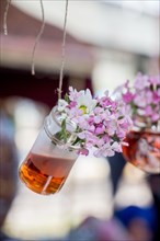 Herbal tea bottle with flowers hanging on string