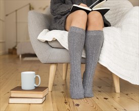Woman wearing knee socks sitting armchair. Resolution and high quality beautiful photo