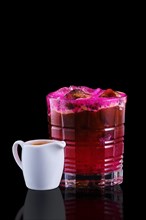 Espresso and tonic with dragon fruit isolated on black background