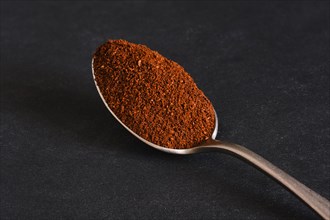 Macro photo of spoon with ground coffee