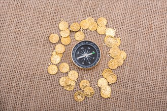 Fake golden coins around the compass instrument