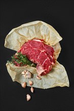 Overhead view of raw beef neck packed in wrapping paper