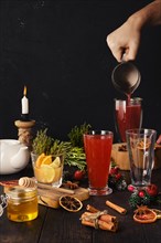 Pouring herbal and fruit tea. Composition with ingredients on the table
