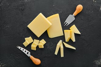 Top view of two kind of semi-soft cheese on dark wooden background