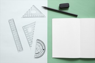Elevated view geometric equipment notebook pencil eraser dual colorful background