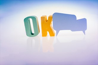 Speech bubble the word OK written with colorful letter blocks