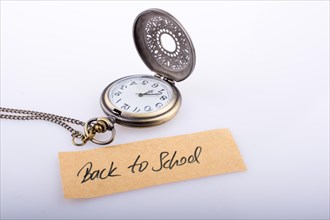 Back to school written title and a pocket watch