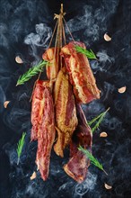 Composition of ssortment of air dried and smoked lamb and beef meat on hanger