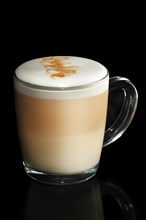 Transparent cup of layered Cappuccino isolated on black
