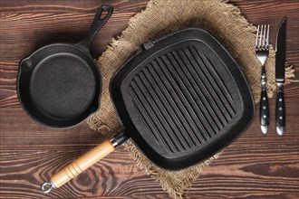 Cast-iron skillet top view on wooden background