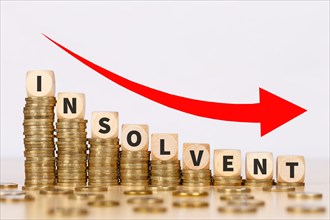 Insolvent symbol image insolvency bankruptcy debt finance and economy money crisis as business concept on coins in Stuttgart