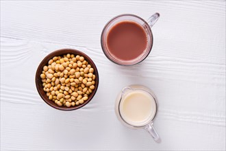 Top view of chocolate milk and soy milk in glass on white table