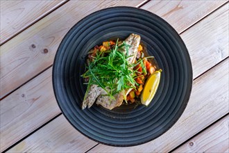 Fried sea fish with vegetables