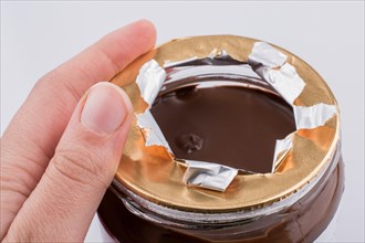 Hand holding a chocolate jar ias healthy sweets