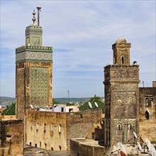 View from above rooftops of two minarets and the 14th century Medersa Bou Inania