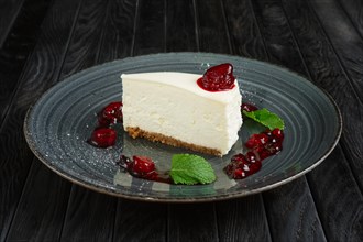 Piece of cheese cake decorated with cherry