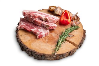 Raw fresh pork brisket slices on wooden cutting board isolated on white