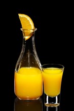 Fresh orange juice as ingredient for vodka cocktail isolated on black
