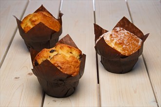Fresh muffins on wooden table. Selective focus photo