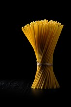 Low key photo of whole wheat ziti pasta. Organic tube spaghetti