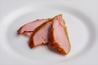 Three slices of ham on a plate
