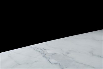 Abstract diagonal background with one part solid black and another white marble