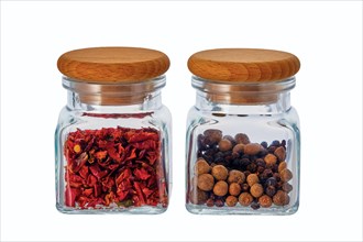 Two jars with spice isolated on white